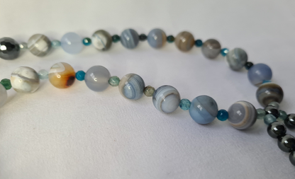 Blue stripey beads on an off white background