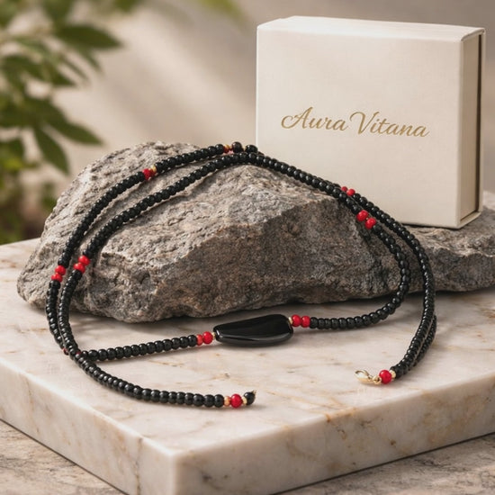 Video showing a close up of the Men's Minimal Necklace sitting on a rock and a white marbled table.