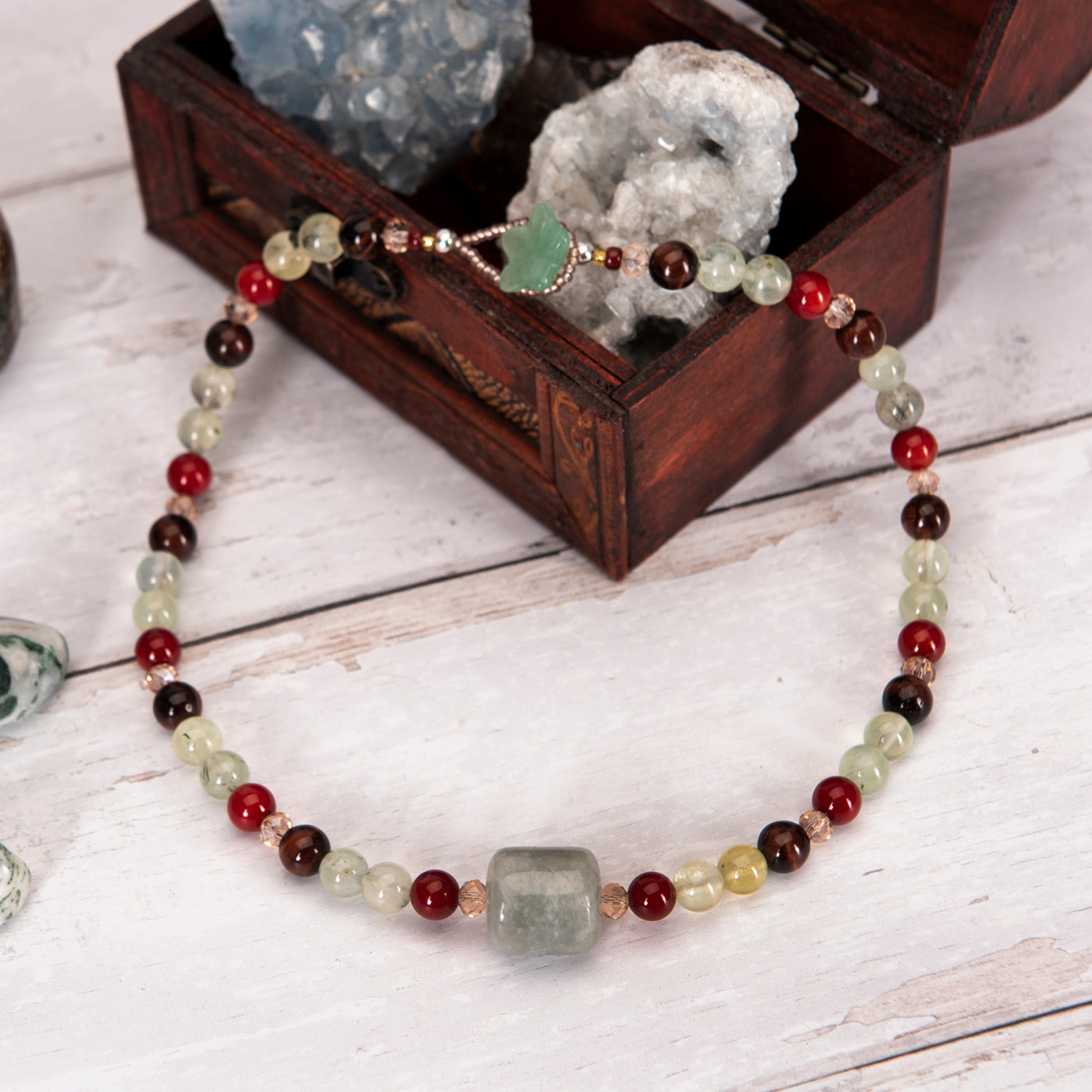 Vibrance necklace on a large crystal in a wooden box